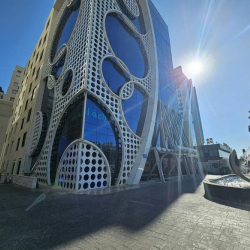 Exterior view of the V Business Center Wadi Abdoun with unique geometric facade and sculpture.
