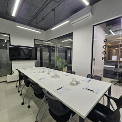 Conference room with black chairs, a TV, and 'Meeting Room' signage.