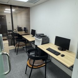 Compact internal office suite with multiple workstations and a shared printer.