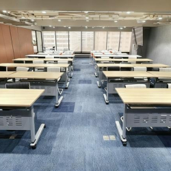 Large seminar room arranged in a classroom layout with rows of desks and chairs.