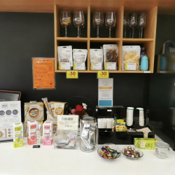 Well-stocked coffee and refreshment station with a variety of snacks and beverages.