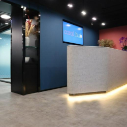 Modern reception area with a textured desk and colorful feature walls.
