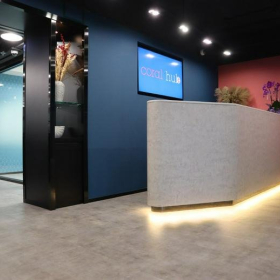 Modern reception area with a textured desk and colorful feature walls.. Click for details.