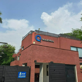 Exterior view of QuickOffice | 304 Upper Mall, Lahore, with its red brick facade and blue brand logo.. Click for details.